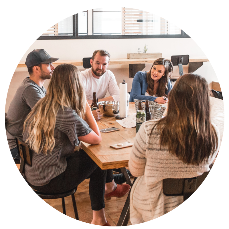 group of co-workers sitting at a table chatting